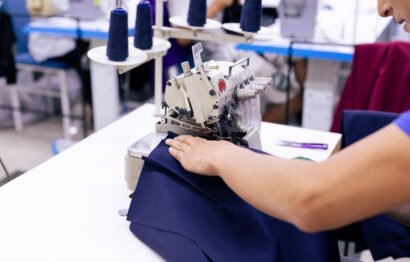 Close up of tailor working on electric sewing machine